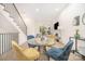 Bright dining area featuring a modern glass table, colorful chairs, and staircase access at 2538 Park Rose Ln # 10, Charlotte, NC 28204