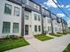 Modern townhome with crisp white exterior and landscaped front yards on a sunny day at 2538 Park Rose Ln # 10, Charlotte, NC 28204