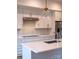Bright kitchen features white cabinetry, gold hardware, stainless appliances, and a stylish pendant light at 2538 Park Rose Ln # 10, Charlotte, NC 28204