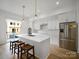 Bright, modern kitchen with stainless steel appliances, white cabinetry, and a large island with counter seating at 2538 Park Rose Ln # 10, Charlotte, NC 28204