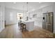 Modern kitchen featuring white cabinets, stainless steel appliances, and a large island with seating at 2538 Park Rose Ln # 10, Charlotte, NC 28204