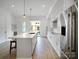Bright kitchen with white cabinetry, stainless appliances, an island, and hardwood floors at 2538 Park Rose Ln # 10, Charlotte, NC 28204