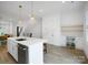 Bright open concept kitchen with a large island and a beverage center with a wine cooler, and hardwood floors at 2538 Park Rose Ln # 10, Charlotte, NC 28204
