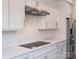 Well-equipped kitchen boasts white cabinetry, stainless steel appliances, modern countertops and stylish backsplash at 2538 Park Rose Ln # 10, Charlotte, NC 28204
