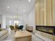 Open living and dining room area featuring hardwood floors, modern fireplace feature and a view of the outdoors at 2538 Park Rose Ln # 10, Charlotte, NC 28204