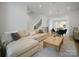Spacious open concept living room with hardwood floors, modern staircase and a view to the dining room and kitchen at 2538 Park Rose Ln # 10, Charlotte, NC 28204