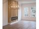 Bright living room featuring fireplace accent wall with custom wood finish and modern light fixture at 2538 Park Rose Ln # 10, Charlotte, NC 28204