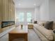 Bright and modern living room with hardwood floors, a comfortable couch and a fireplace featuring modern design at 2538 Park Rose Ln # 10, Charlotte, NC 28204