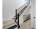 Modern staircase with dark railings and light wood steps, offering a sleek design at 2538 Park Rose Ln # 10, Charlotte, NC 28204