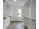 Spacious walk-in closet featuring ample shelving and hardwood floors at 2538 Park Rose Ln # 10, Charlotte, NC 28204