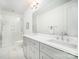 Bright bathroom featuring a double sink vanity, large mirror, and a tiled walk-in shower at 2542 Park Rose Ln # 9, Charlotte, NC 28204