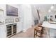 View of the dining area and kitchen featuring a wine fridge, staircase, and modern design at 2542 Park Rose Ln # 9, Charlotte, NC 28204