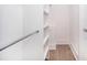 Organized walk-in closet with built-in shelving and a hanging rod for ample storage space at 2542 Park Rose Ln # 9, Charlotte, NC 28204