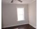 Simple bedroom with dark hardwood floors and a ceiling fan at 303 Vance Ave, Salisbury, NC 28144