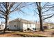 Rear view of a single story house with mature trees and a small yard at 303 Vance Ave, Salisbury, NC 28144