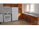 Galley kitchen with wood cabinets and white appliances at 303 Vance Ave, Salisbury, NC 28144
