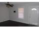 Simple living room featuring dark hardwood floors and a ceiling fan at 303 Vance Ave, Salisbury, NC 28144