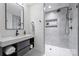 Modern bathroom with a walk-in shower, floating vanity, and a large mirror at 3113 Colyer Pl, Charlotte, NC 28205
