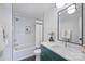 Modern bathroom with a teal vanity, white subway tile, and hexagon floor tile at 3113 Colyer Pl, Charlotte, NC 28205