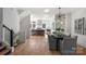 Open concept dining area with grey chairs and hardwood floors at 3113 Colyer Pl, Charlotte, NC 28205