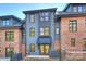 Rear view of a modern home with brick and blue siding, showcasing a patio and landscaping at 3113 Colyer Pl, Charlotte, NC 28205