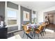 Modern dining room with wood table, leather chairs, and gray accent wall at 4140 Claret Cup Dr # 36, Kannapolis, NC 28083