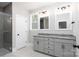 Modern bathroom featuring double vanity with gray cabinets, granite countertops, and a glass-enclosed shower at 4251 Candlewood Dr, Sherrills Ford, NC 28673