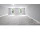 Spacious, carpeted bonus room with natural light from two windows, perfect for recreation or entertainment at 4251 Candlewood Dr, Sherrills Ford, NC 28673