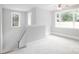 The bonus room has neutral paint, carpet, and trim with multiple windows at 4251 Candlewood Dr, Sherrills Ford, NC 28673
