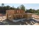 Two-story home being framed showing windows, covered porches, and the brick-lined foundation at 4251 Candlewood Dr, Sherrills Ford, NC 28673