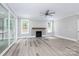 Bright living room with fireplace, ceiling fan, and sliding glass doors to the porch at 4251 Candlewood Dr, Sherrills Ford, NC 28673