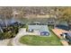 Aerial view of a charming blue house on a well-maintained lawn by a lake with docks at 4257 Candlewood Dr # 7, Sherrills Ford, NC 28673