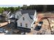 A side view of a white two story house with a dark roof and stone accents under construction at 4257 Candlewood Dr # 7, Sherrills Ford, NC 28673