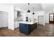 Well-lit kitchen with a navy island, white cabinets, stainless steel appliances, and hardwood flooring at 4257 Candlewood Dr # 7, Sherrills Ford, NC 28673