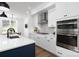 Modern kitchen with white cabinetry, stainless steel appliances, a large island, and sleek finishes at 4257 Candlewood Dr # 7, Sherrills Ford, NC 28673