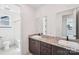 Bright bathroom featuring double sinks with granite countertops and modern fixtures at 604 Hyder Trl, Tega Cay, SC 29708