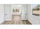 Empty bedroom featuring neutral walls, hardwood floors, and double glass doors at 604 Hyder Trl, Tega Cay, SC 29708