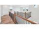 Bright hallway with hardwood floors and modern railing overlooking the living space at 604 Hyder Trl, Tega Cay, SC 29708