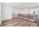 Open hallway featuring hardwood floors, modern railing, and ample natural light at 604 Hyder Trl, Tega Cay, SC 29708