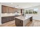 Modern kitchen with granite countertops, stainless steel appliances, wood flooring, and custom cabinets at 604 Hyder Trl, Tega Cay, SC 29708
