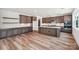 Elegant kitchen featuring wood floors, a central island, and modern cabinetry with marble backsplash, ready for cooking at 604 Hyder Trl, Tega Cay, SC 29708