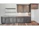 Open kitchen featuring marble countertops, custom cabinets, floating shelves, and wood flooring, perfect for entertaining at 604 Hyder Trl, Tega Cay, SC 29708