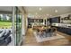 Open kitchen with island, stainless appliances, dark cabinets, and adjacent breakfast area with backyard views at 604 Hyder Trl, Tega Cay, SC 29708