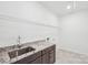Laundry room features a utility sink, granite countertops, and storage shelves at 604 Hyder Trl, Tega Cay, SC 29708