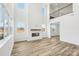 Spacious living room with a fireplace, high ceilings, and loft overlooking living space at 604 Hyder Trl, Tega Cay, SC 29708