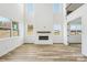 Bright living room with a fireplace and large windows providing plenty of natural light at 604 Hyder Trl, Tega Cay, SC 29708