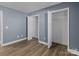 Bedroom with gray walls, double door closet, and wood flooring at 700 Leonard Ave, Kannapolis, NC 28081