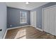 Well-lit bedroom with gray walls, double-door closet and wood floor at 700 Leonard Ave, Kannapolis, NC 28081
