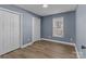 Bright bedroom with gray walls, white double doors, and wood flooring at 700 Leonard Ave, Kannapolis, NC 28081