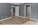 Bedroom with gray walls, wood flooring, and access to a small bathroom at 700 Leonard Ave, Kannapolis, NC 28081
